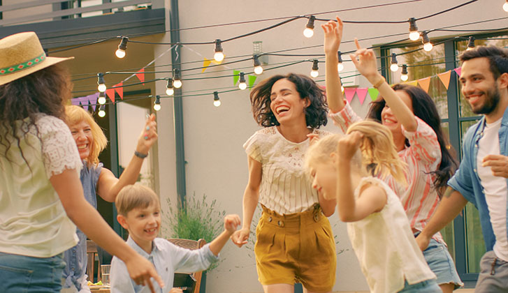 Family and Friends Dancing together at the Garden Party Celebration. Young and Elderly People Having Fun on a Sunny Summer Day Disco.